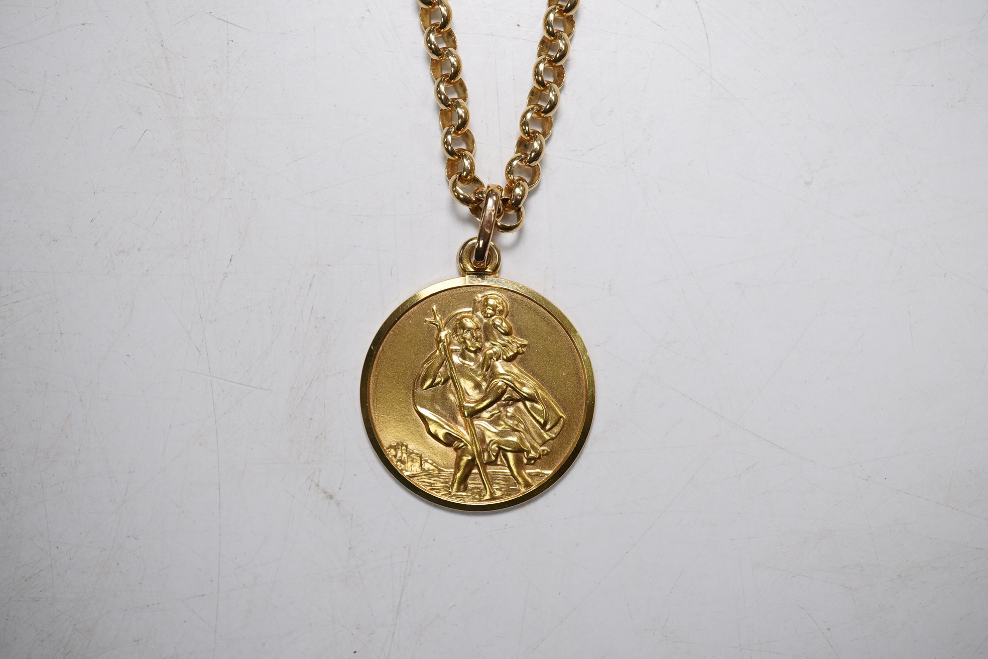 A modern Italian Uno-A-Erre 9k Saint Christopher pendant, on a 9ct gold chain (chain clasp a.f.), 23.5 grams. Condition - poor and good.